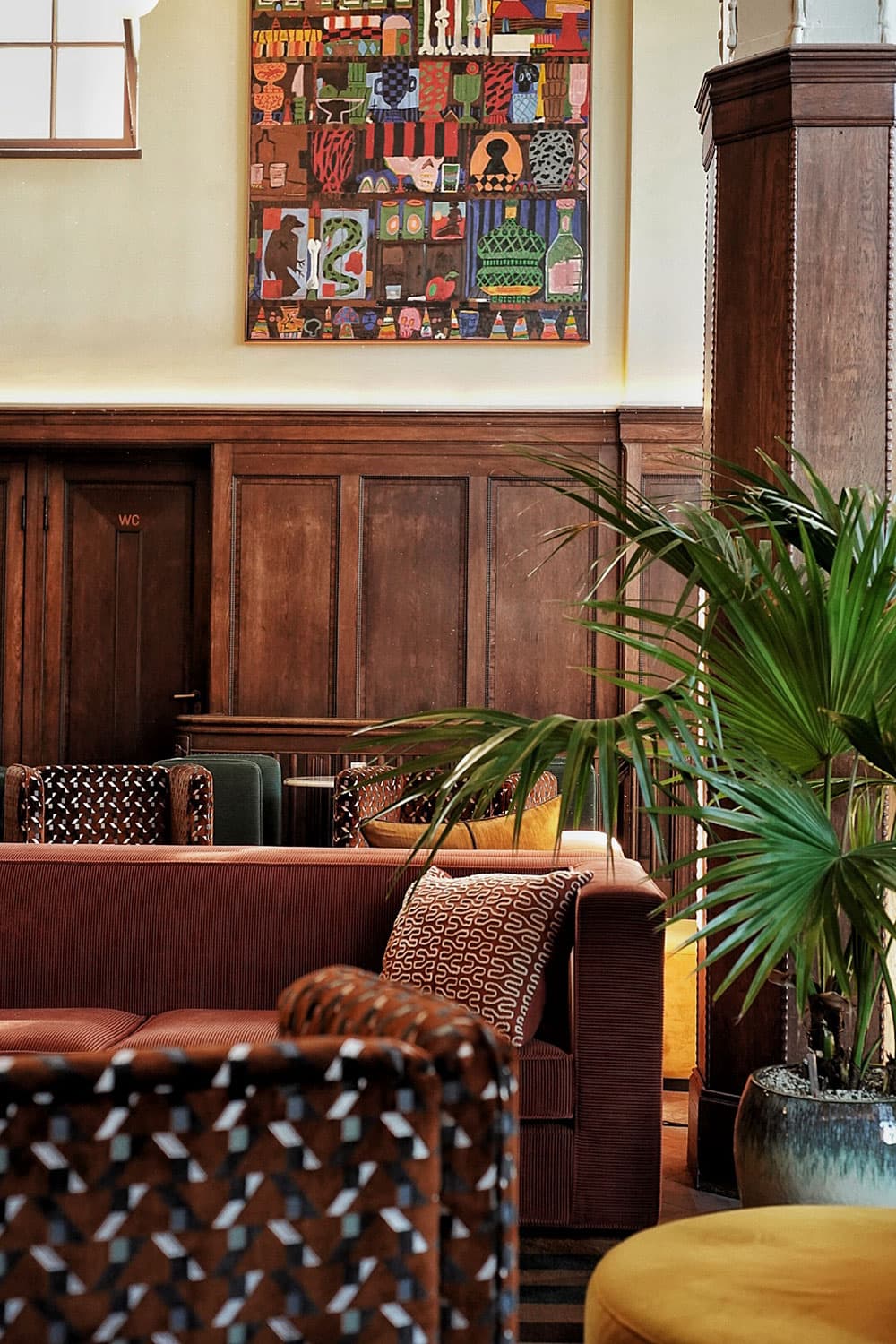 Empty interior showing the pastel-shaded upholstery and wooden wall sconces